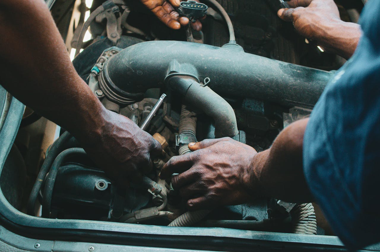 Crafting Captivating Headlines: Your awesome post title goes here Close-up of mechanics working on a vehicle engine, showing teamwork and precision in car maintenance.